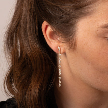 Silver crystal drop earrings with long row of teardrop stones and hoop ends