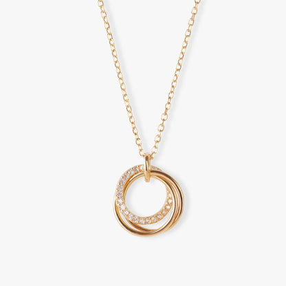 Gold-tone ring pendant necklace with crystal pavé accents on stacked circles