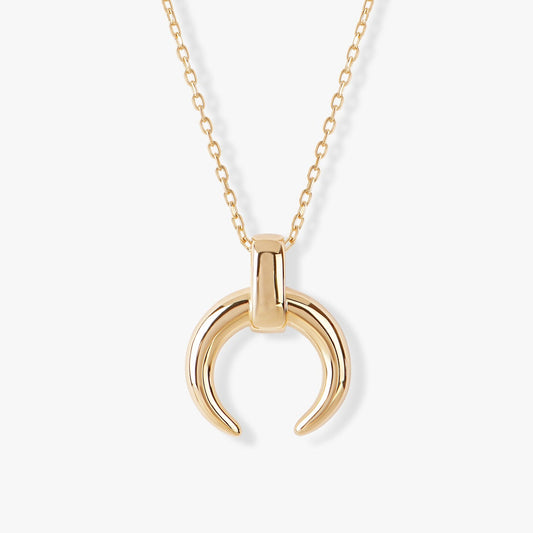 Gold necklace with a unique pendant on a white background