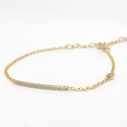 Gold-tone beaded bracelet with slim clear stone bar
