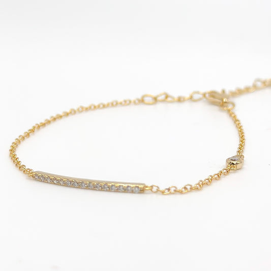 Gold-tone beaded bracelet with slim clear stone bar