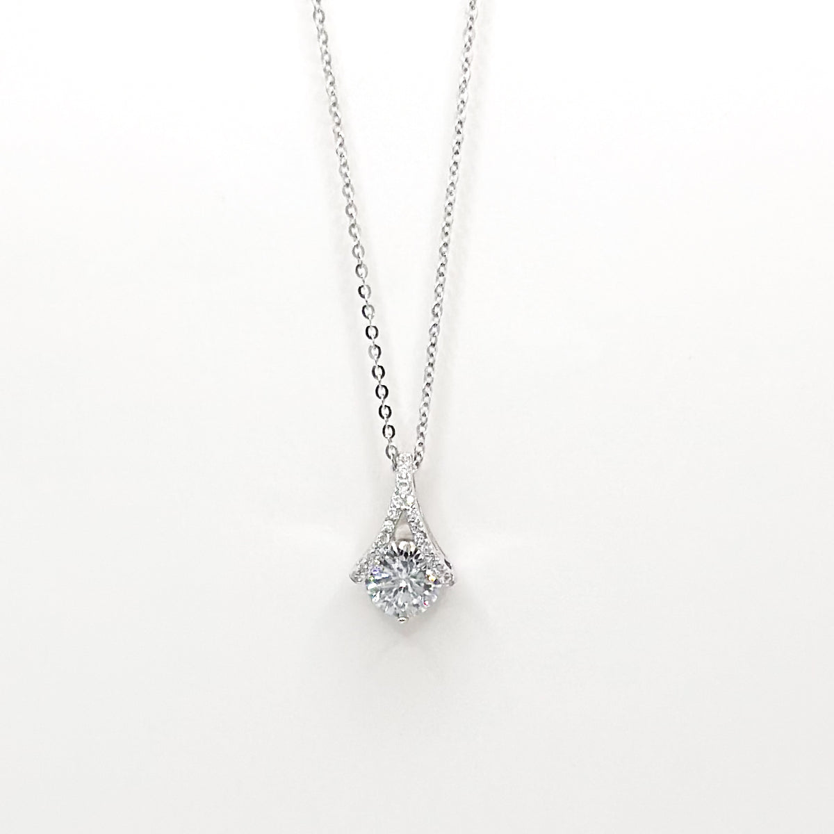 Silver-tone necklace with round halo gemstone pendant and delicate chain
