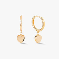 Gold heart huggie earrings with round hoop and dangling heart charm