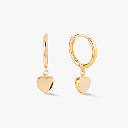 Gold heart huggie earrings with round hoop and dangling heart charm