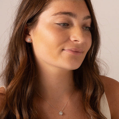 Lab-grown moissanite necklace with square pendant at neckline on fine chain