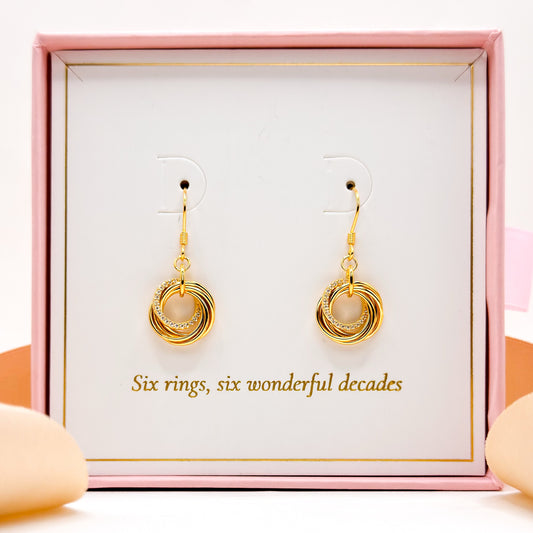Gold-tone 60th birthday drop earrings with stacked ring circles and pink center