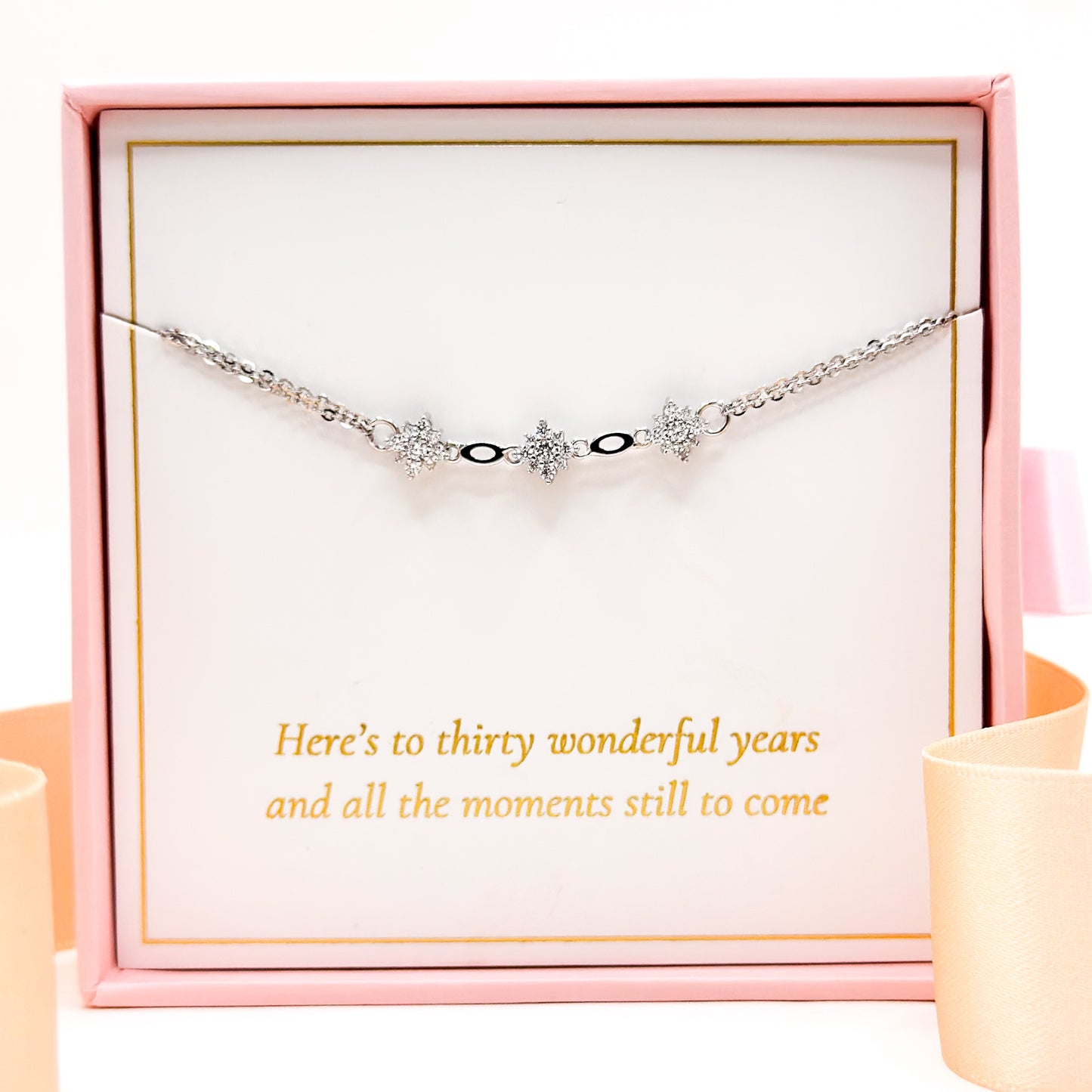 Silver bracelet with three star charms and small black accents