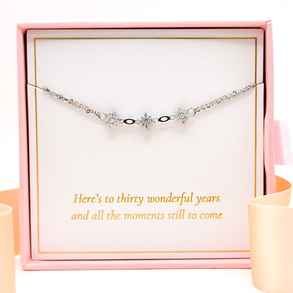 Silver bracelet with three star charms and small black accents