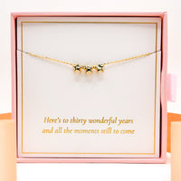 Gold star necklace with three small dangling star charms on a thin chain