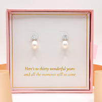 Pearl drop earrings with round clear stones on stud tops