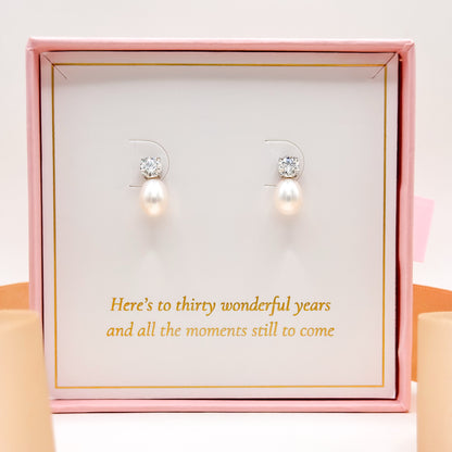 Pearl drop earrings with round clear stones on stud tops