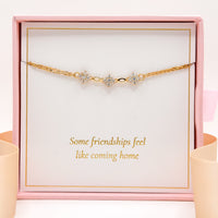 Gold-tone friendship bracelet with three star charms and small clear stones