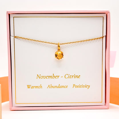 Gold-tone chain necklace with round citrine gemstone pendant