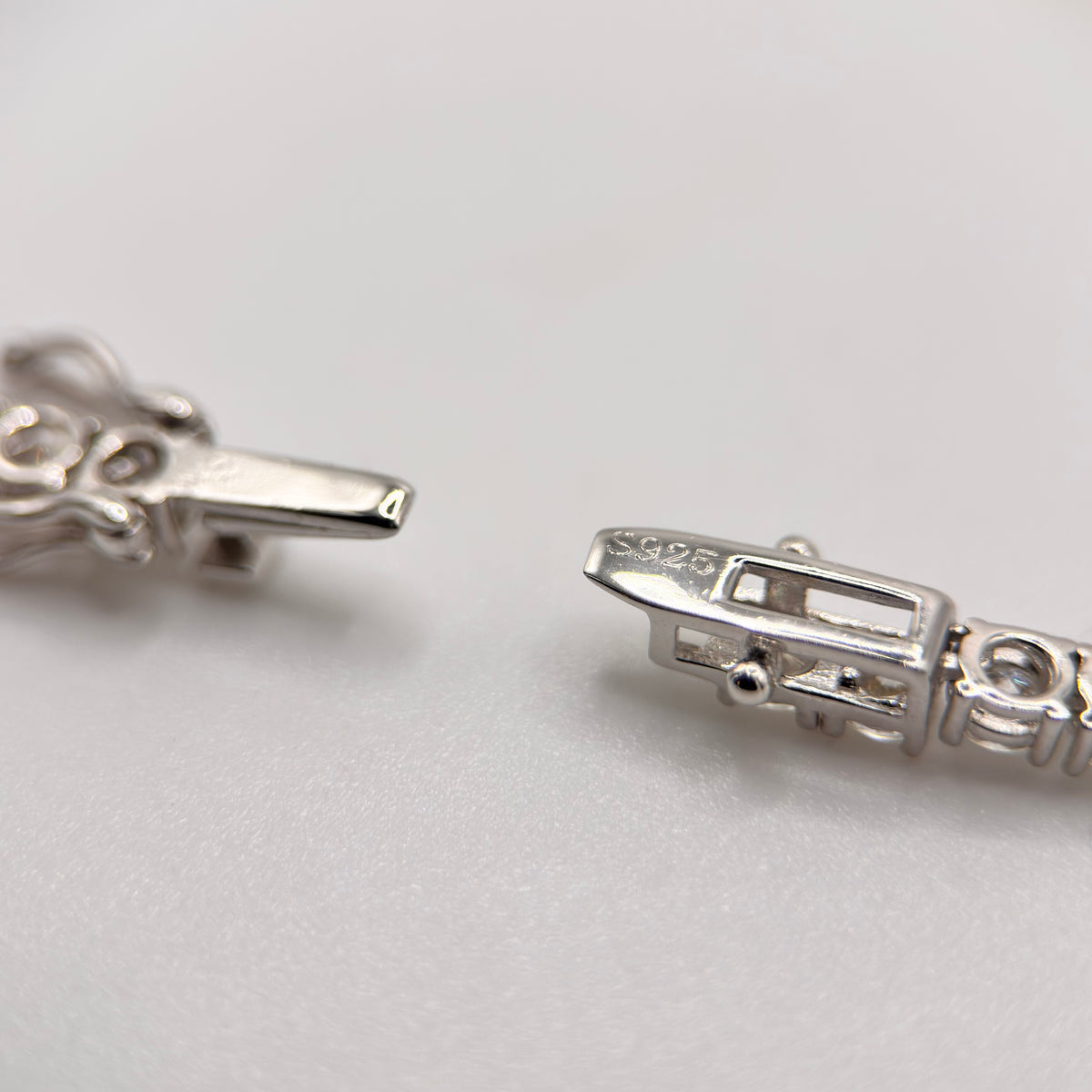 Moissanite tennis necklace clasp detail with rectangular settings, silver-toned