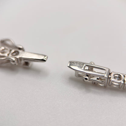 Moissanite tennis necklace clasp detail with rectangular settings, silver-toned