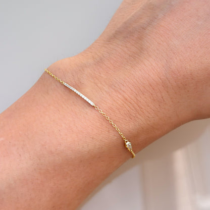 Gold and silver-toned layered bracelet with clear stone accents