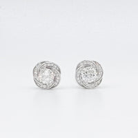Floral moissanite stud earrings with round center stones in a halo, silver-tone