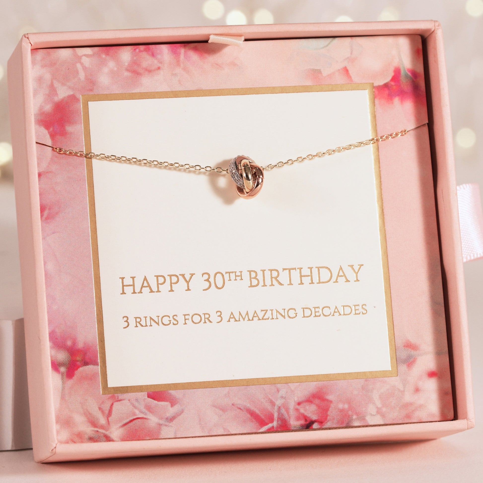 Necklace with knot charm in a pink floral box with a 30th birthday message
