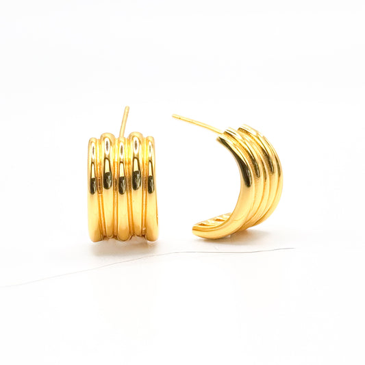 Chunky half hoop earrings, gold-tone with small dark insets and ridged bands