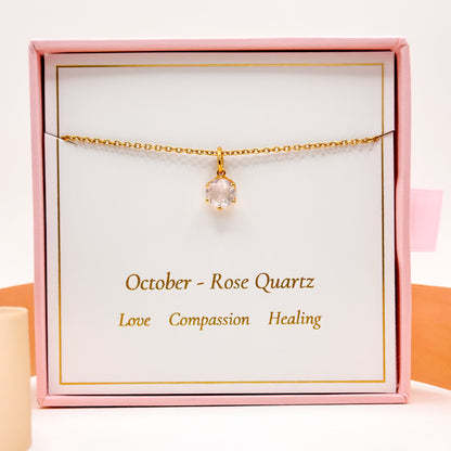 Gold-tone chain necklace with round pink gemstone pendant