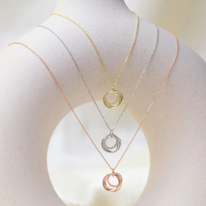 Multitone 4-ring pendant necklaces on mannequin, circular stacked rings on thin chains