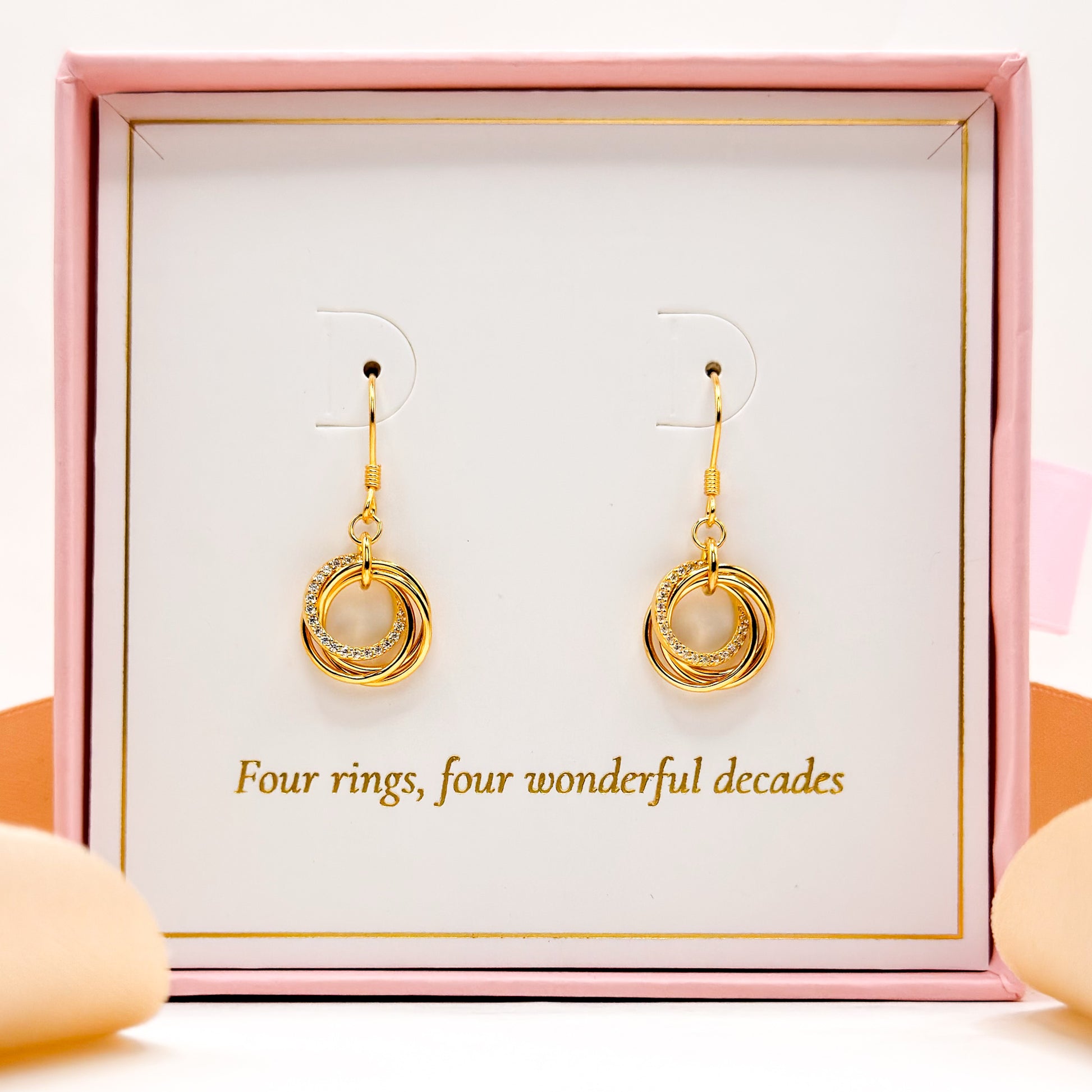 Gold ring-drop hoop earrings on display card with two hanging pairs