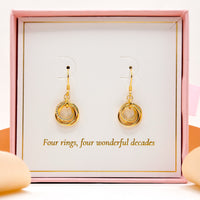 Gold ring-drop hoop earrings on display card with two hanging pairs