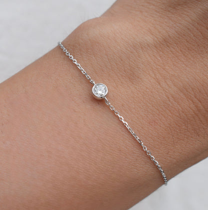 Moissanite bracelet on wrist with round white stone and silver link chain
