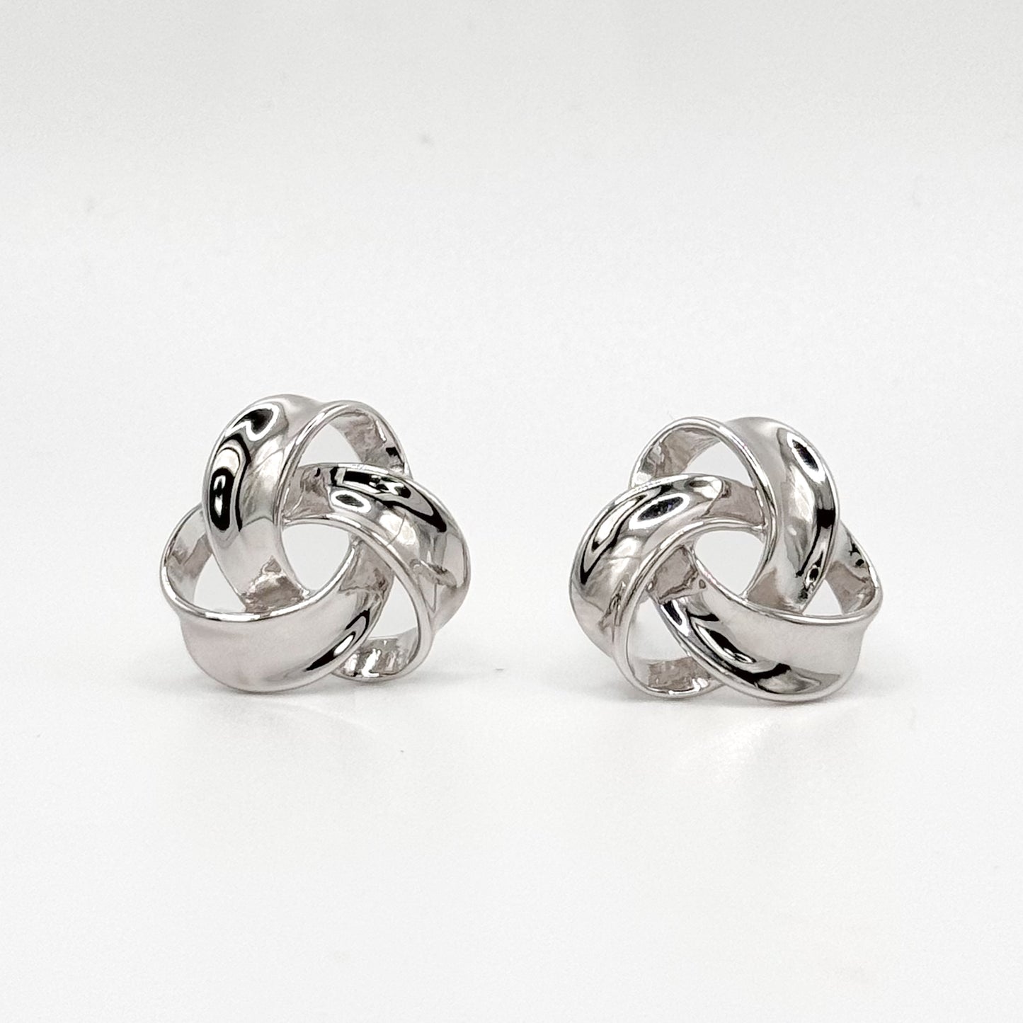 Chunky knot sterling silver hoop earrings with polished swirl design