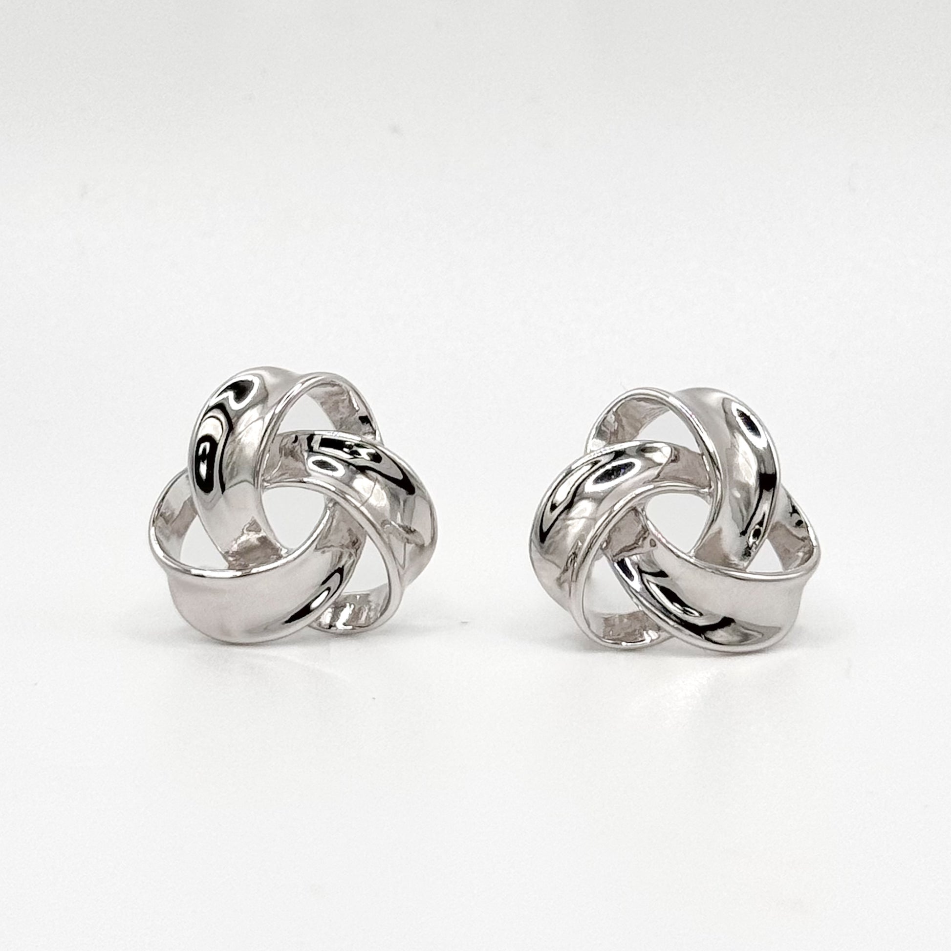 Chunky knot sterling silver hoop earrings with polished swirl design