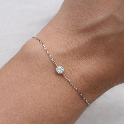 Moissanite bracelet on wrist with sparkling round stone and silver links