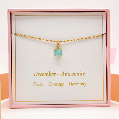 Gold necklace with round blue-green gemstone pendant on fine chain