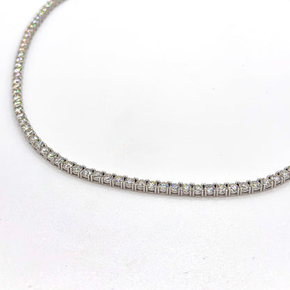 Tennis necklace with round moissanite stones in a silver-toned setting