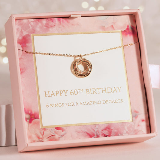 Rose gold necklace with a card in a pink floral box, celebrating a 60th birthday.