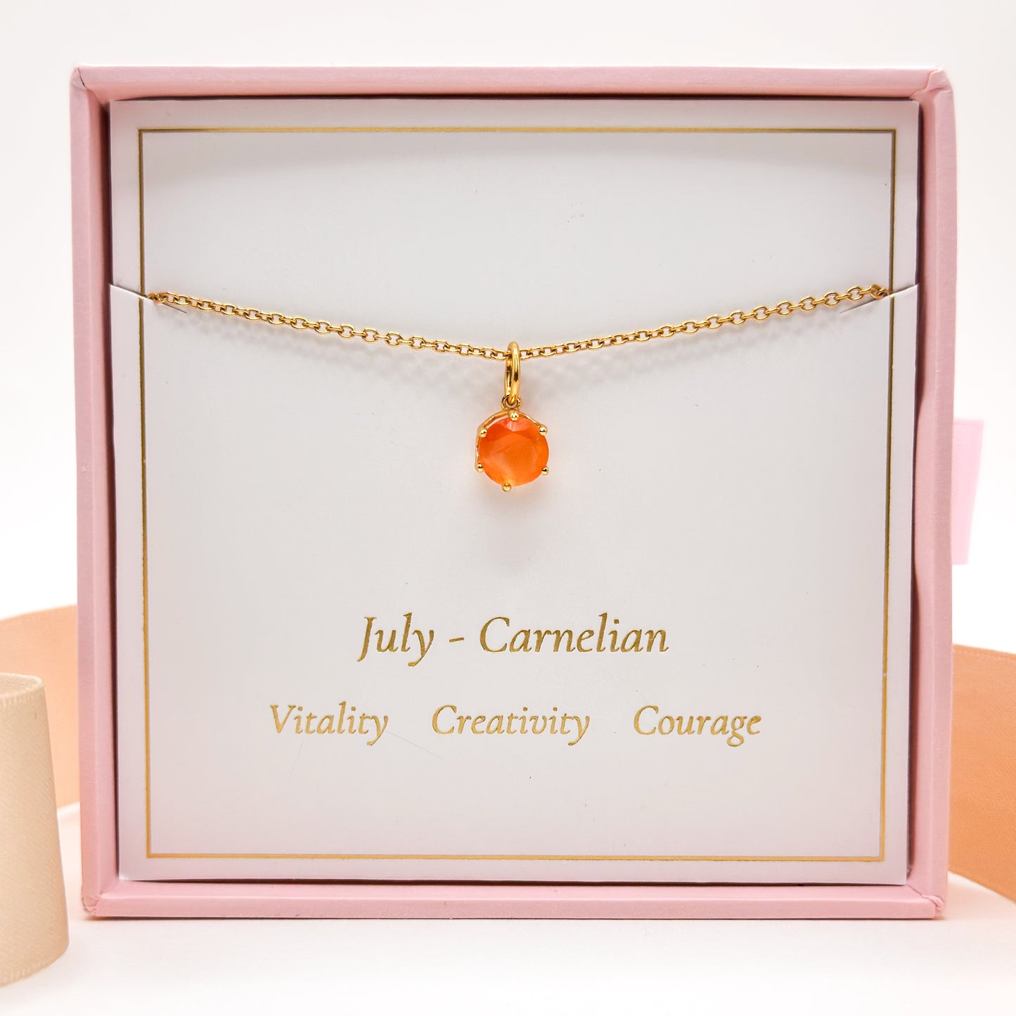 Gold-tone chain necklace with round orange carnelian pendant