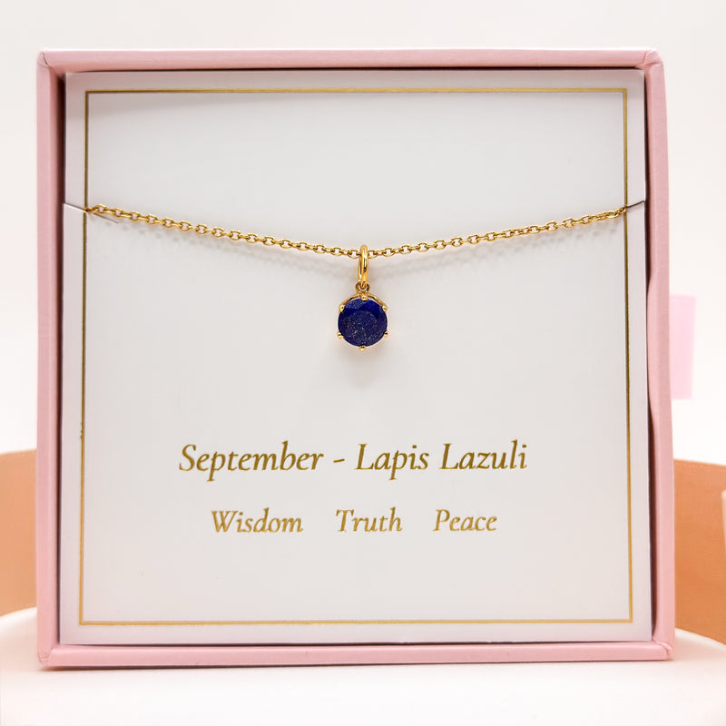 Gold chain necklace with round blue lapis lazuli pendant, in jewelry box