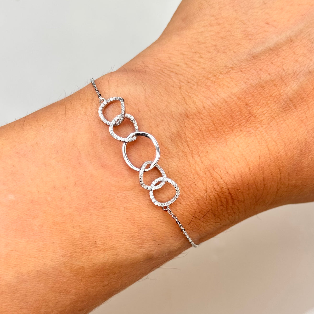 Silver-tone 5-link ring bracelet with five circular hoop links and crystal-like details