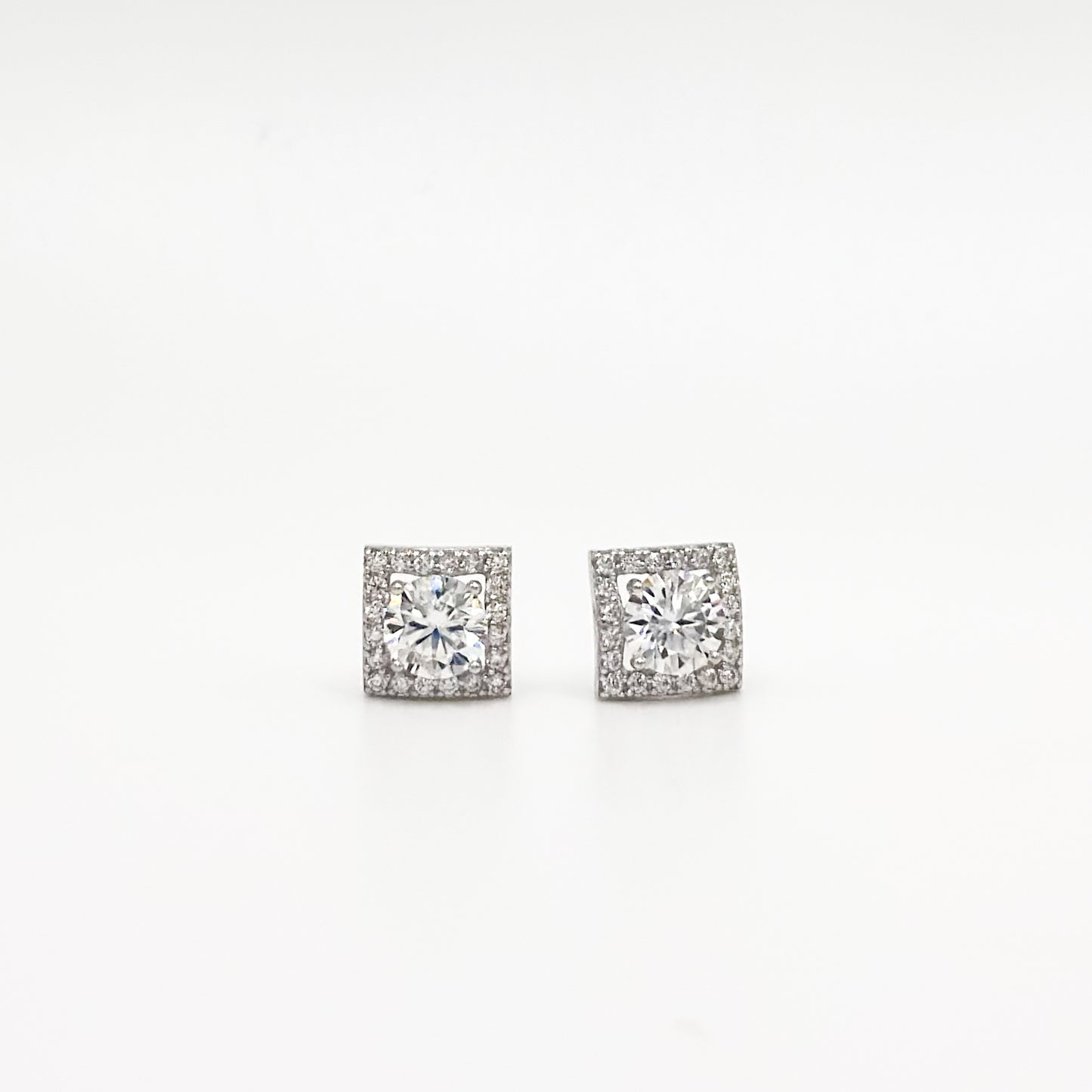 Pair of square cushion moissanite stud earrings, clear stones in silver-toned settings