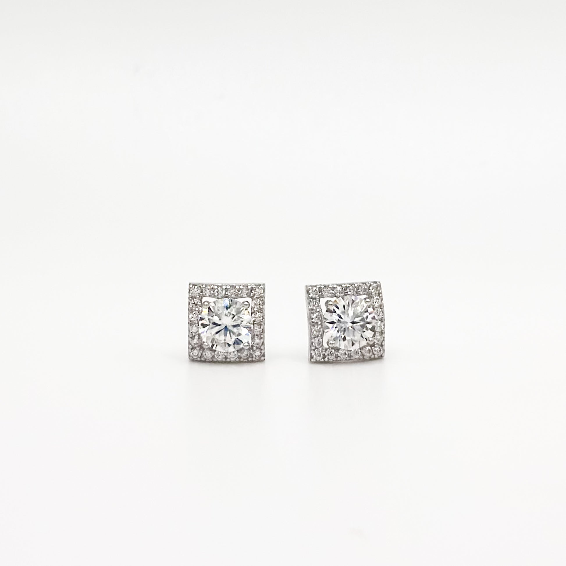 Pair of square cushion moissanite stud earrings, clear stones in silver-toned settings