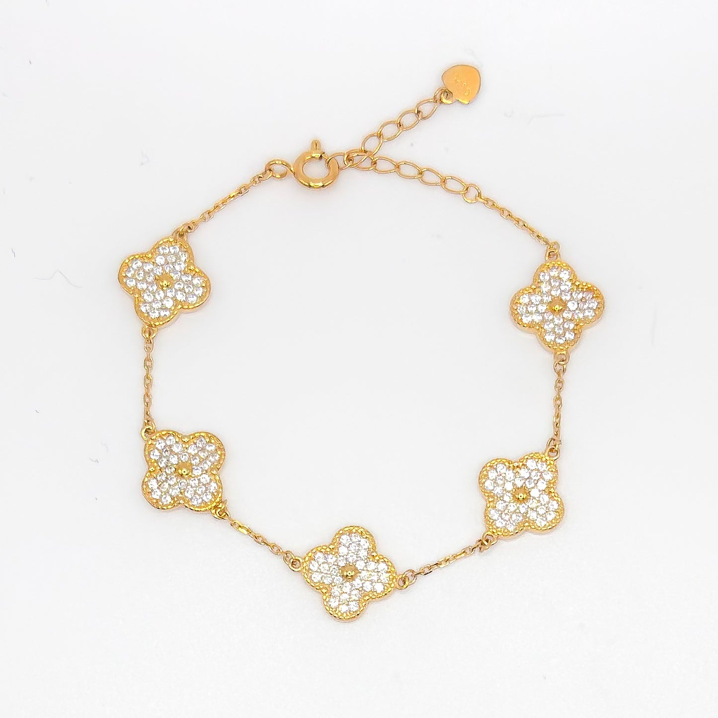 Gold clover bracelet with five small pave flower charms and link chain.