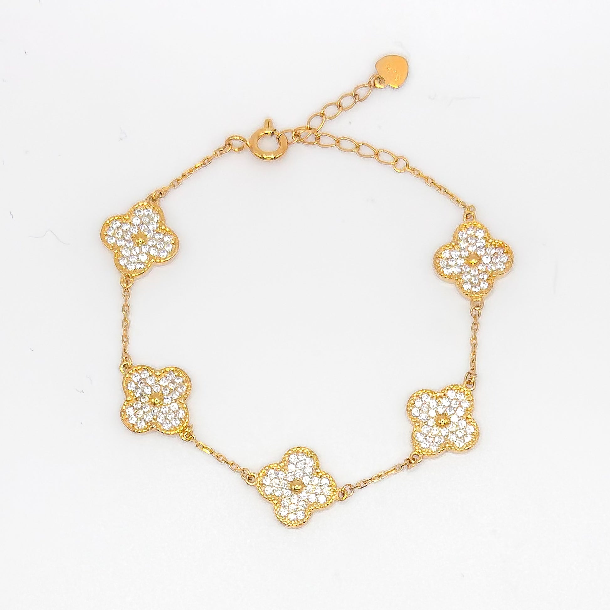 Gold clover bracelet with five small pave flower charms and link chain.