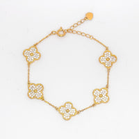Gold clover bracelet with five small pave flower charms and link chain.