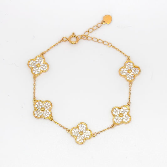 Gold clover bracelet with five small pave flower charms and link chain.