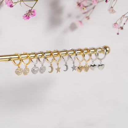 Star and moon charm hoop earrings in gold and silver tones
