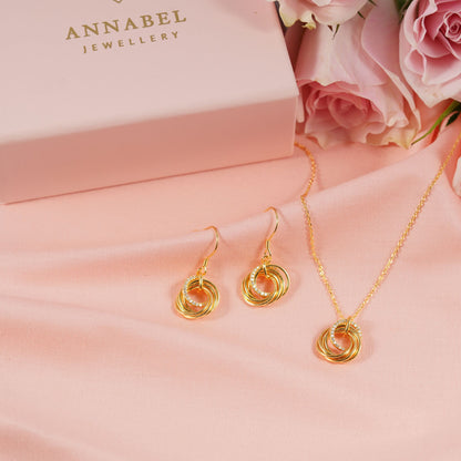 Gold-tone ring hoop earrings with layered spiral circles, dangling on hooks