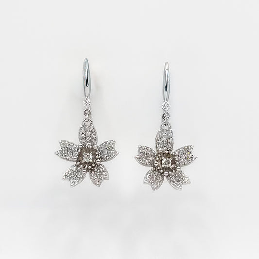 Sterling silver flower drop earrings with dangling star-shaped floral charms