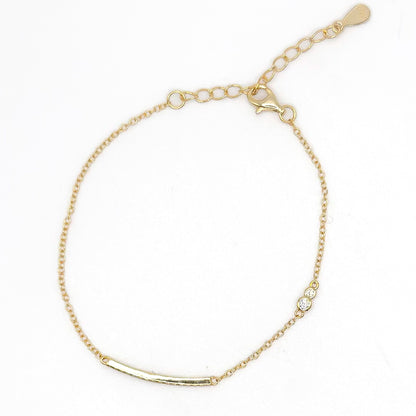 Gold-tone chain bracelet with dolphin charm and round stone detail