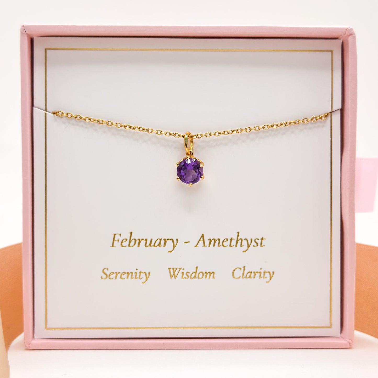 Gold-tone amethyst pendant necklace with small purple round gemstone