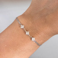 Silver-tone charm bracelet with three star-shaped clusters and oval links