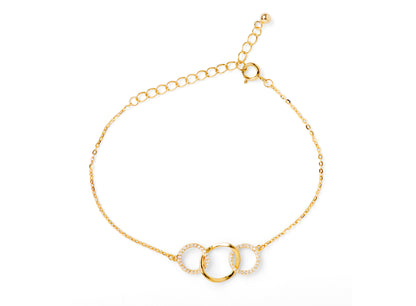 Gold chain bracelet with three linked ring charms